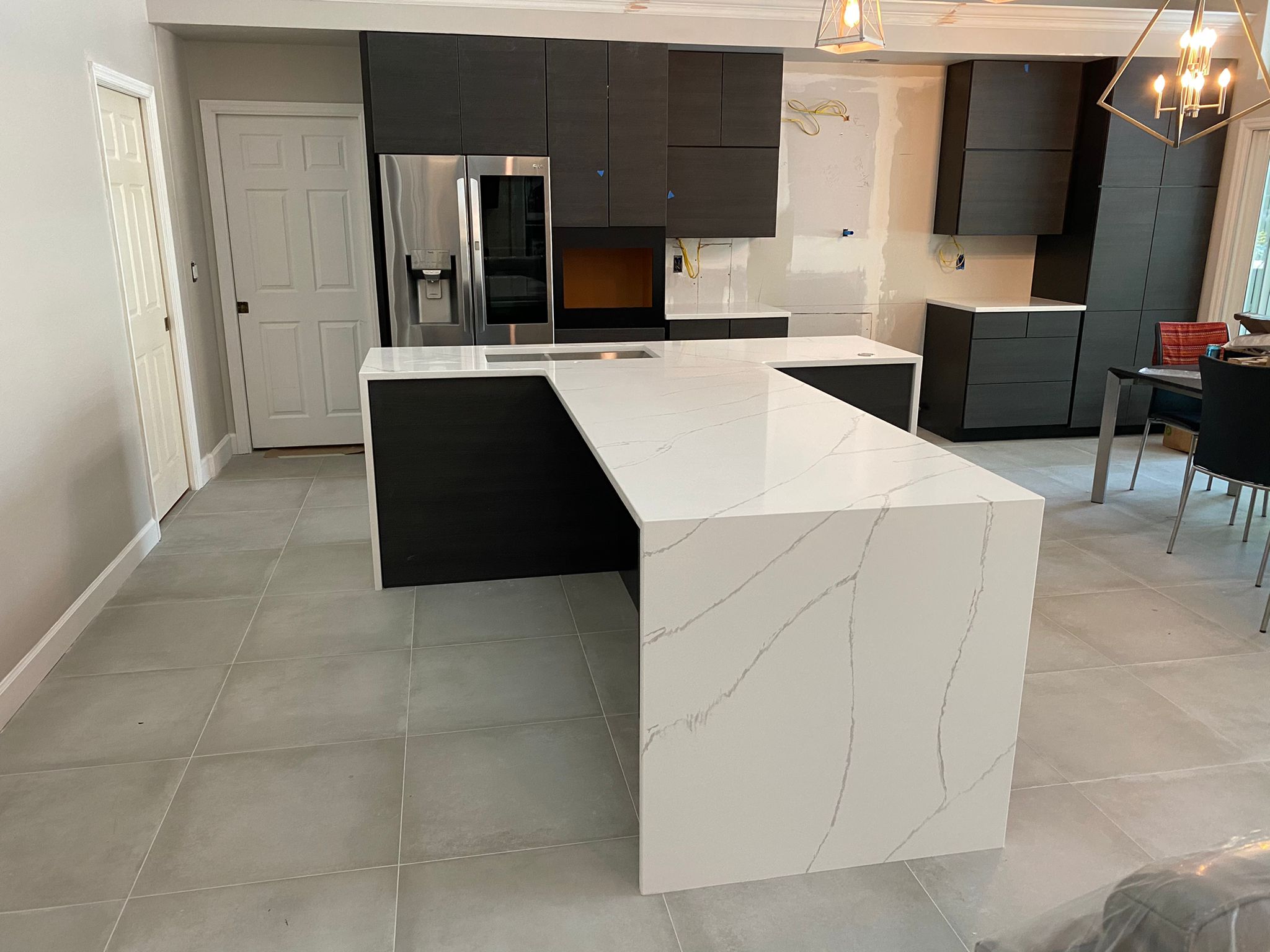 Luxury kitchen with black cabinets and white marble countertops