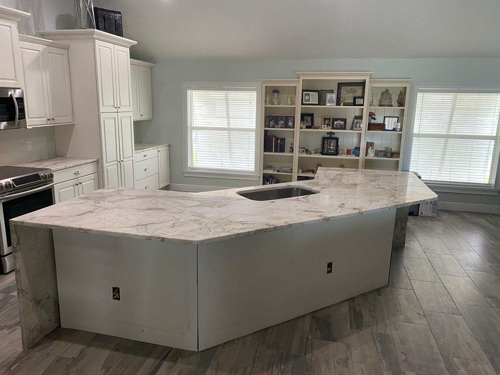 Elegant kitchen with white cabinets and marble countertops